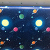 A vibrant space scene featuring colorful planets, stars, and nebulas on a dark blue background.