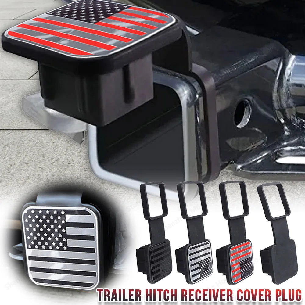 A black trailer hitch receiver cover plug featuring an American flag emblem.