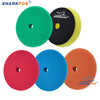 A set of four colored car polishing sponge pads for dual-action polishers in green, black, yellow, and red.