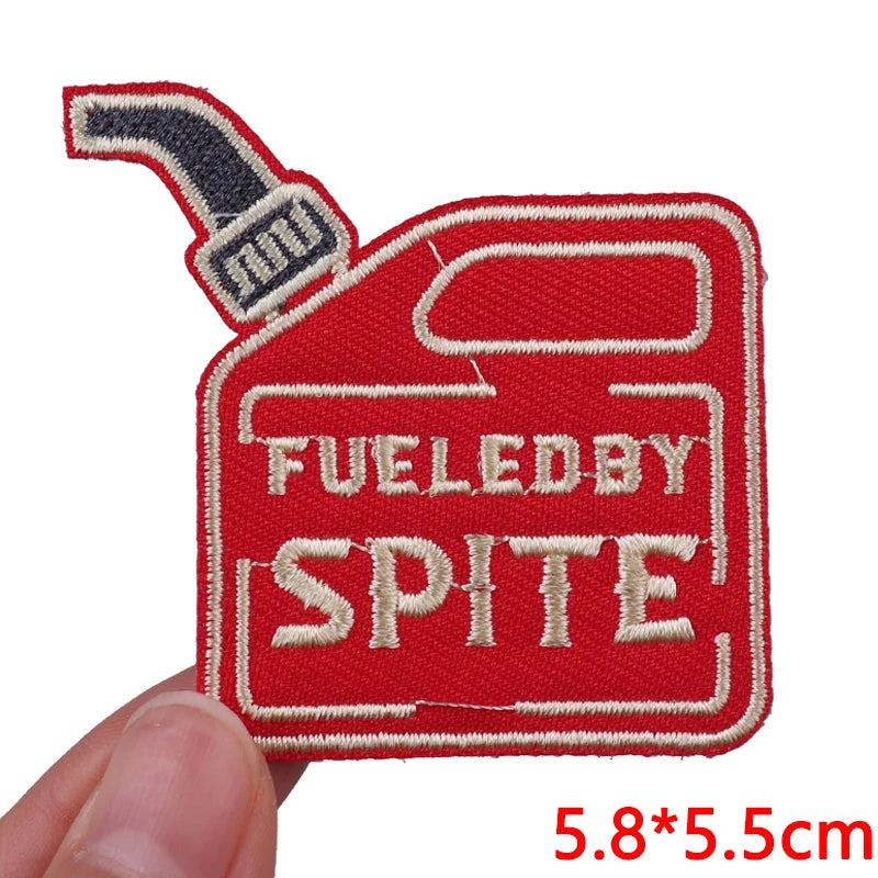 Red embroidered iron-on patch featuring the text FUELED BY SPITE on a white background
