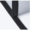 Close-up view of a black self-adhesive window mosquito net screen being applied to a window frame.