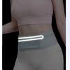 A woman wearing a light pink sports bra and white athletic pants with a translucent glowing waist pack.