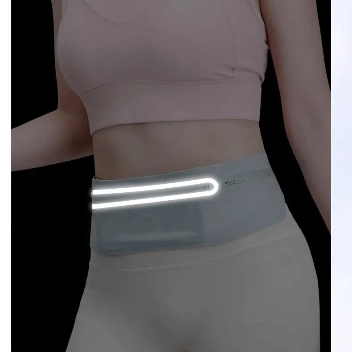 A woman wearing a light pink sports bra and white athletic pants with a translucent glowing waist pack.