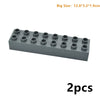 A rectangular gray building blocks set with multiple studs, shown from the side.