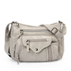 A light beige leather tote bag with a flap closure and adjustable strap.