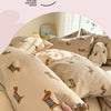 A close-up of a beige duvet cover set featuring a cute dog print design, showing the fabric texture and detail.
