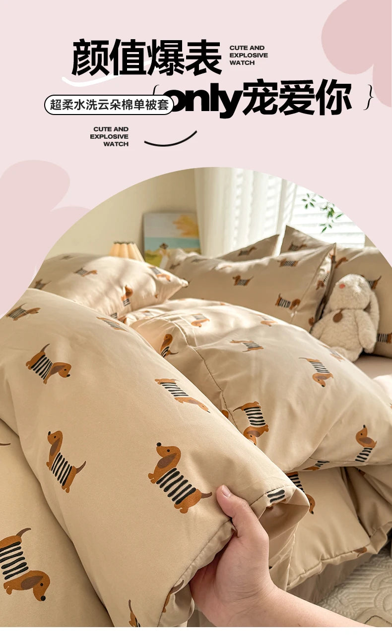 A close-up of a beige duvet cover set featuring a cute dog print design, showing the fabric texture and detail.