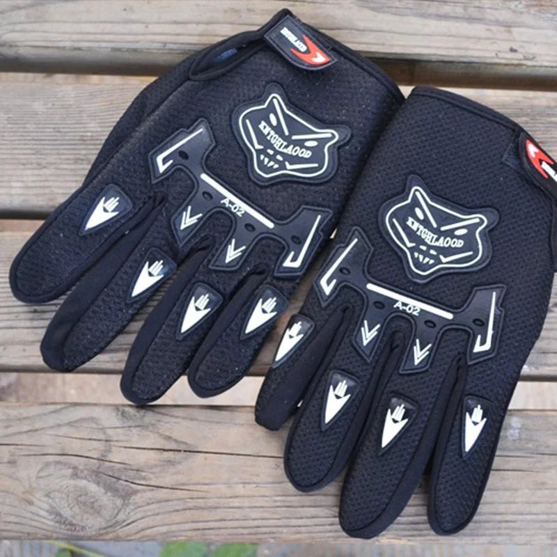 A pair of black full finger nylon riding gloves with anti-slip grips resting on a wooden surface.