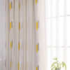 Elegant white curtain fabric featuring embroidered wheat stalks and yellow accents with a lace trim.