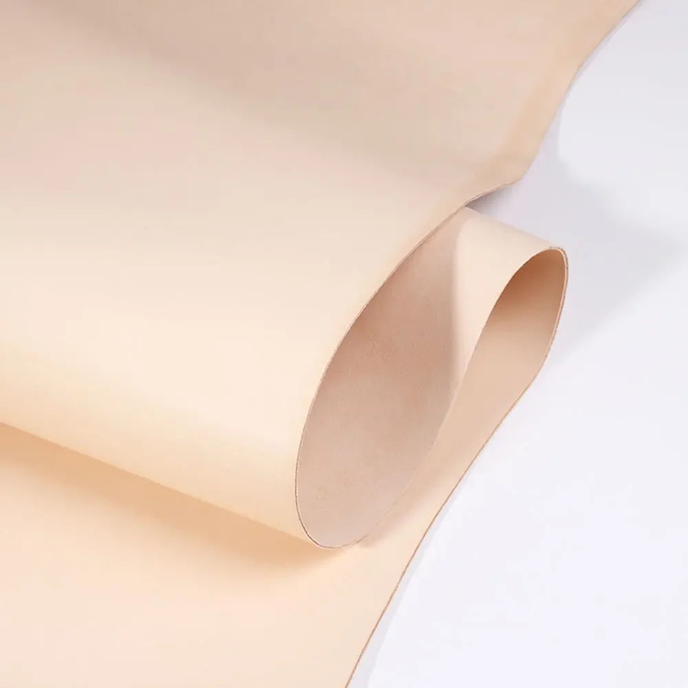 A rolled piece of light tan vegetable-tanned full grain leather for crafting.