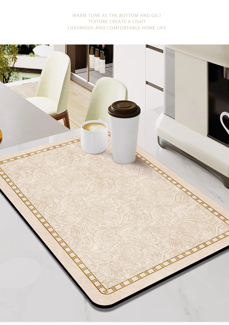 A beige and gold patterned counter mat is displayed on a white marble surface with ceramic cups.