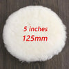 A round white wool polishing pad measuring 5 inches or 125mm resting on a dark wooden surface.