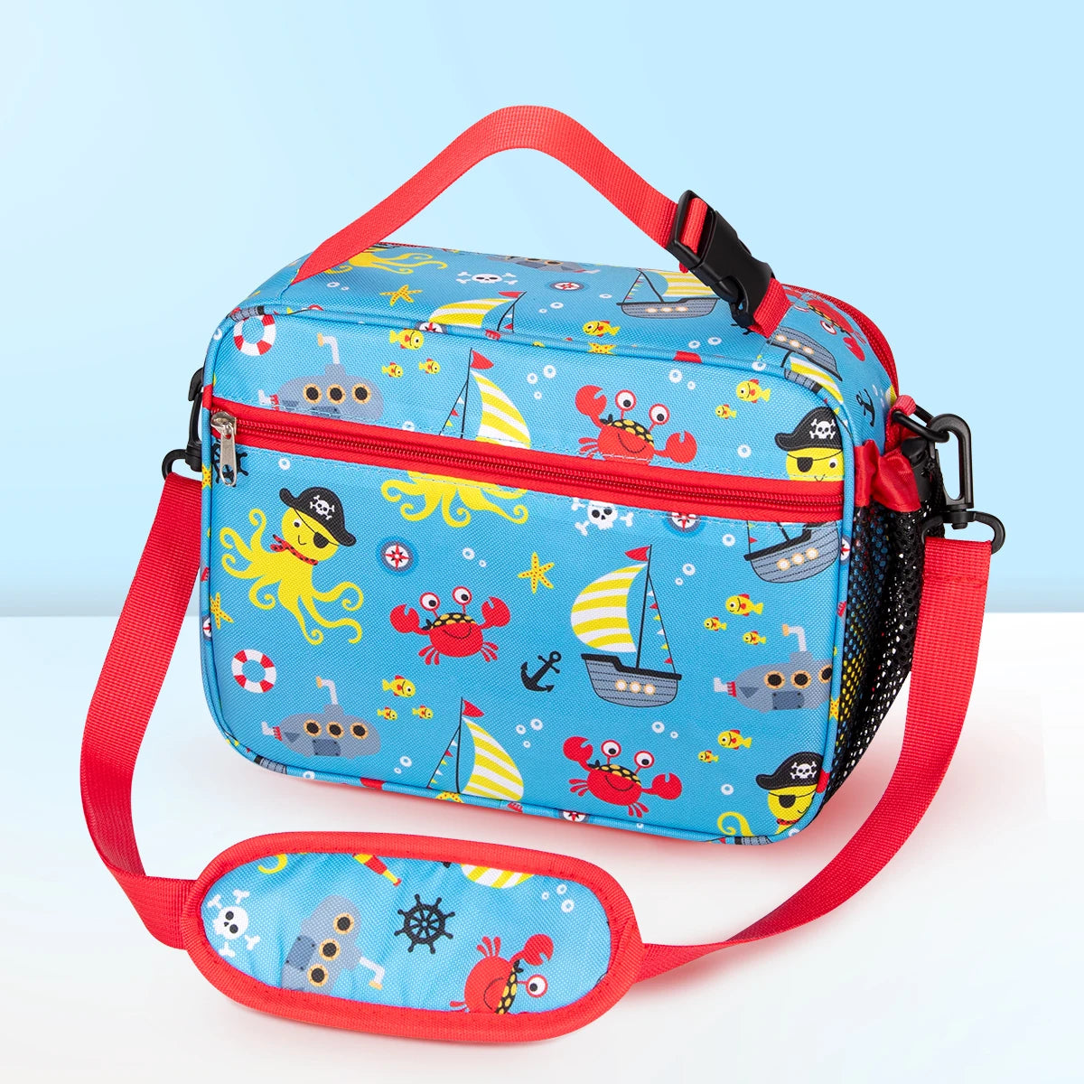 A blue insulated lunch bag with a red strap featuring cartoon sea creatures and boats.