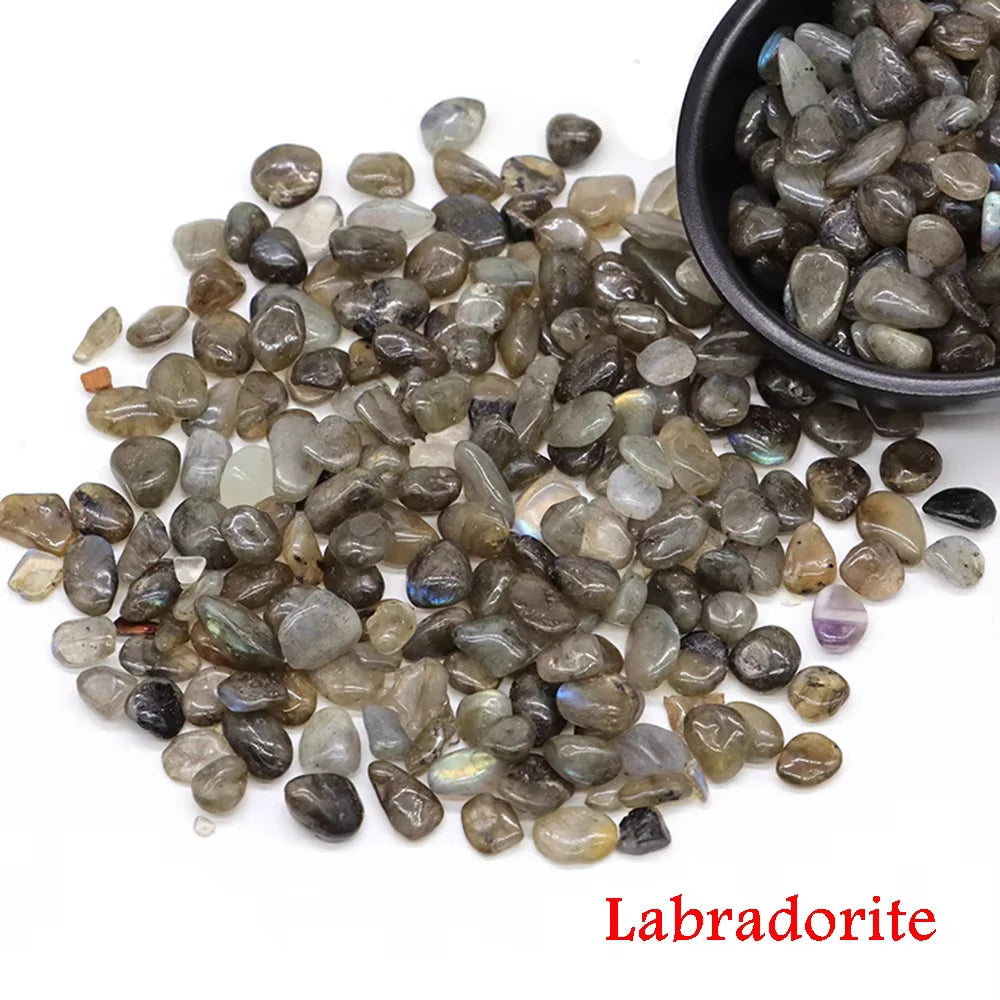 A pile of tumbled labradorite crystal stone chips in various shades of gray and blue.
