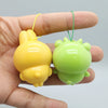 A yellow and green PVC bag pendant doll is held in a hand, featuring an adorable usagi and hachiware design.
