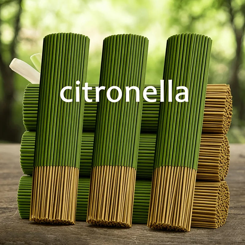 Green citronella incense sticks standing upright in a wooden container.