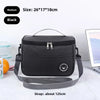 Black insulated lunch bag with a shoulder strap shown on a white surface.
