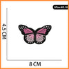 Five embroidered iron-on patches of pink and black butterfly designs.