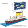 A model kit of a cruise ship built from interlocking plastic blocks, shown next to its packaging.