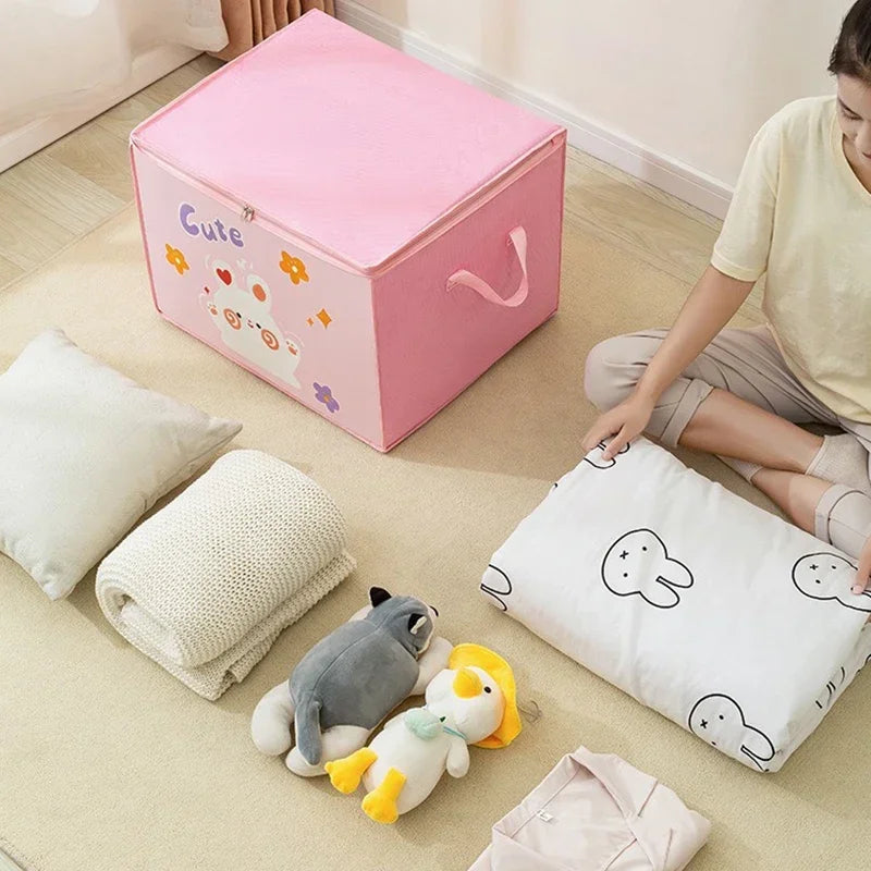 A pink foldable storage box is shown with white pillows and a light-colored blanket on a beige floor.