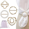 A set of gold-toned metal rings and clips designed for fastening shirts and scarves.