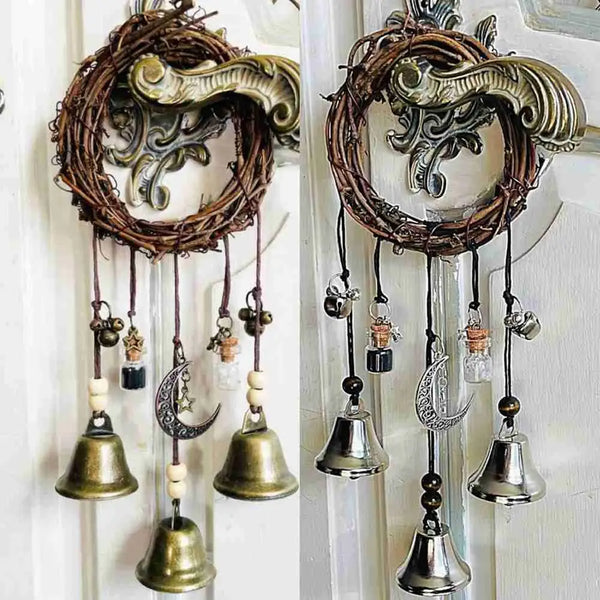 A set of rustic metal witch bells and wind chimes hanging on a white door.