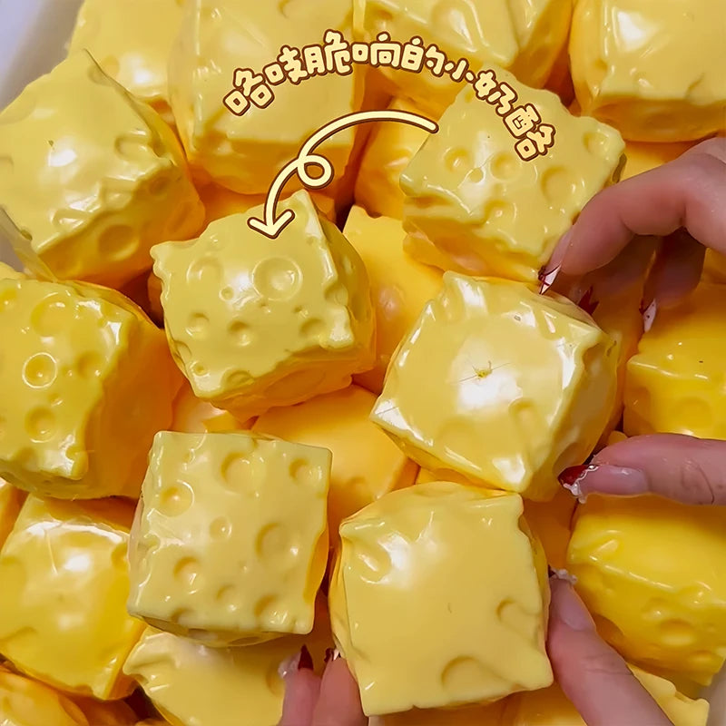 A close-up shot of yellow, squishy fidget cubes being held by a hand.