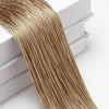 Golden metallic beaded thread curtain hanging, showing the texture and length of the fabric.