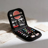 A black compact travel sewing kit is open, displaying various tools including scissors, needles, and thread spools.