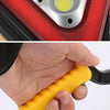 Close-up of a red emergency triangle warning light with three yellow reflectors and a yellow handle.