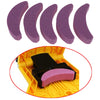 A set of purple sharpening stones for a portable chainsaw sharpener, shown alongside the device.