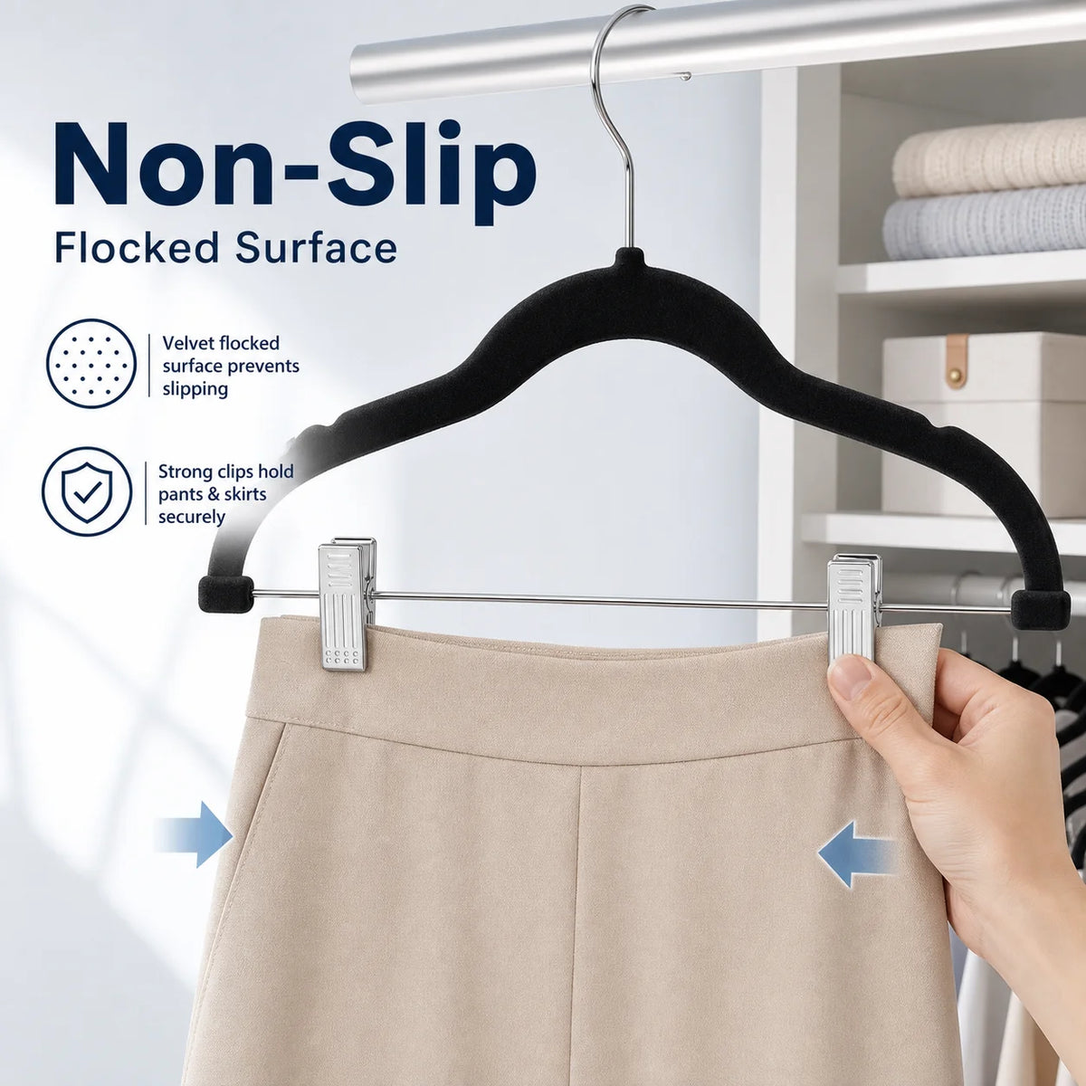 A hanger with a velvet flocked surface is shown hanging a pair of light beige trousers.