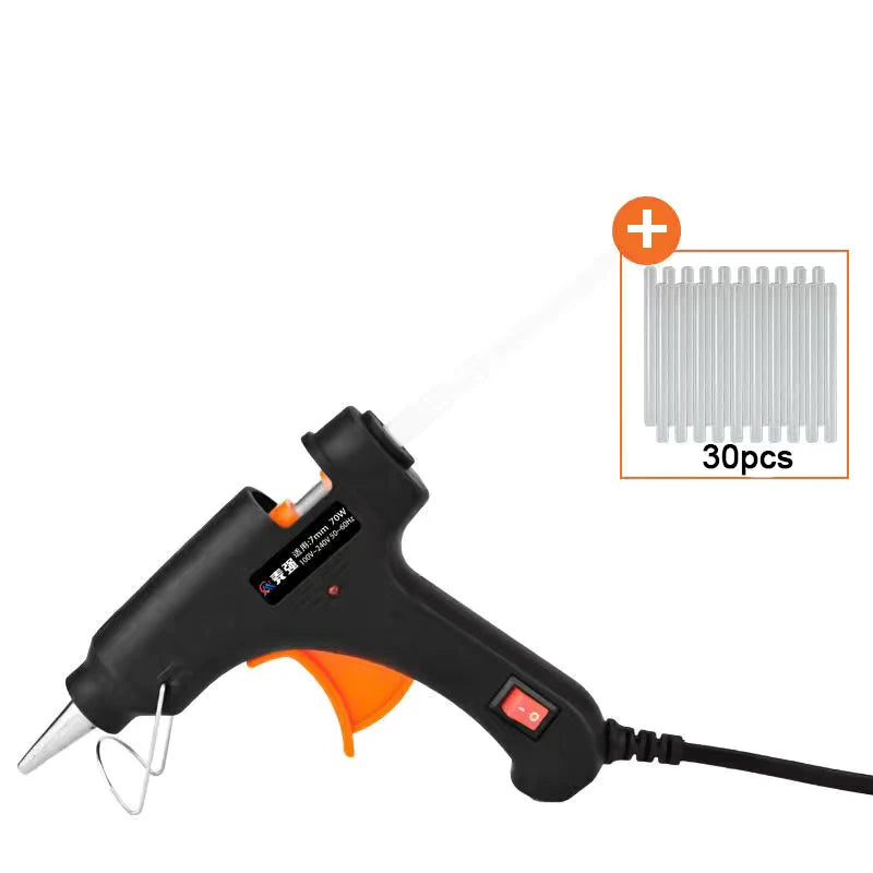 Black hot melt glue gun with a nozzle and glue sticks shown against a white background.