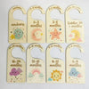 A set of wooden baby closet dividers with cartoon labels for newborn, 0-3 months, 3-6 months, and toddler ages.