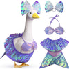 A white lawn goose statue wearing a purple iridescent mermaid bikini costume with sheer purple wings.