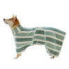 A dog wearing a striped, quick-dry bathrobe outdoors.