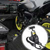 Close-up of heavy duty retractable ratchet straps with yellow and black components on a motorcycle.