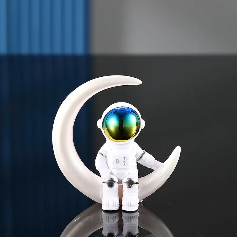 A white astronaut figurine with a reflective visor is displayed on a dark surface.