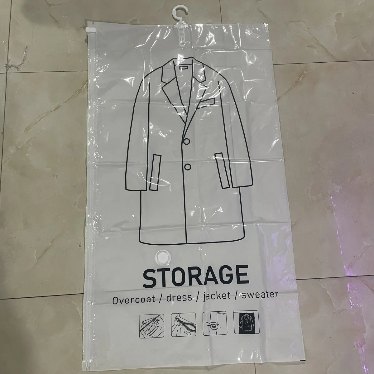 Clear plastic storage bag with a hanger outline showing how to pack an overcoat, dress, jacket, or sweater.