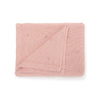A folded soft pink cotton baby blanket with a breathable knit texture.