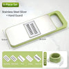 A stainless steel slicer set with a hand guard and five interchangeable blades shown on a light green cutting board.