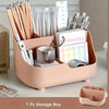 A pink storage box filled with various office and school supplies including pens, pencils, scissors, and rulers.