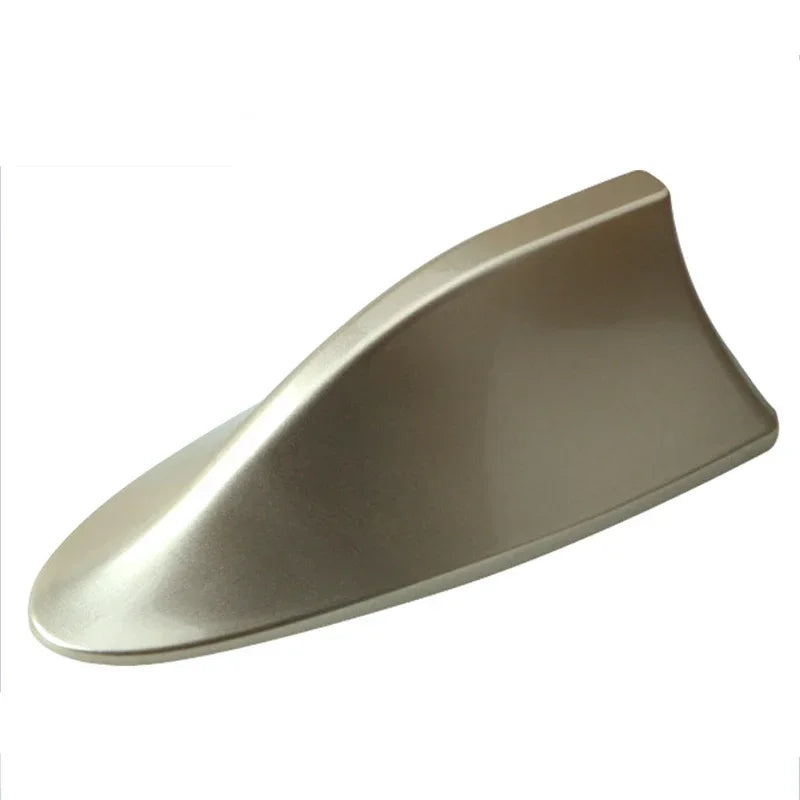 A silver shark fin car antenna with FM/AM signal enhancement.