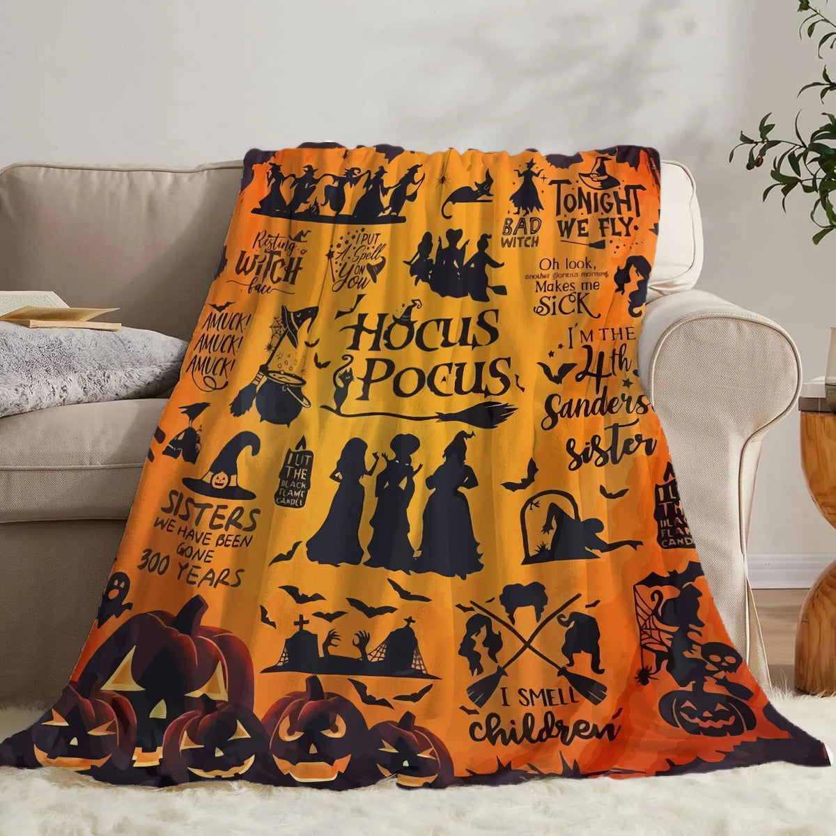 Orange Halloween themed flannel throw blanket featuring spooky designs for cozy decor