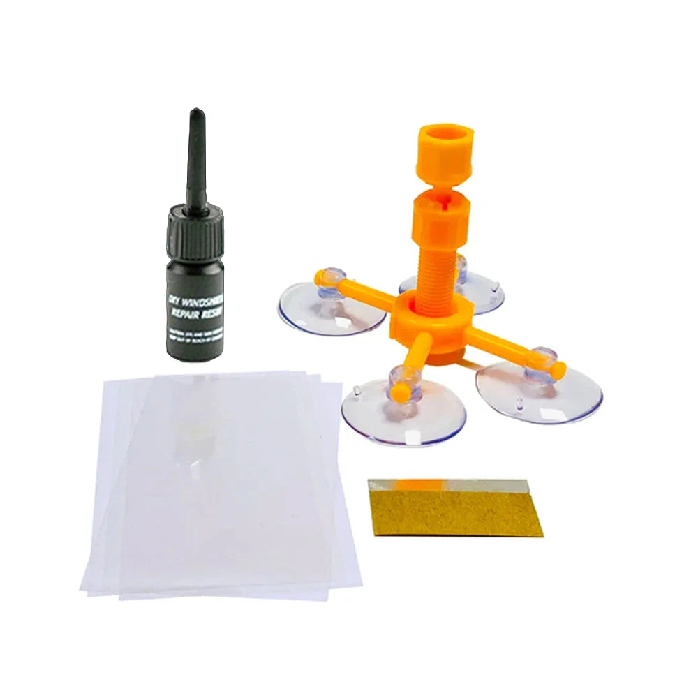 DIY windshield repair kit showing a repair resin bottle, an orange tool, and adhesive discs.
