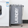 A gray foldable laundry basket with a metal frame is shown next to a white washing machine.