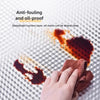 A hand wipes oil stains from an anti-fouling and oil-proof surface layer.