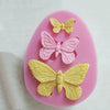 Pink silicone mold shaped like a butterfly for crafting soap, chocolate, or resin