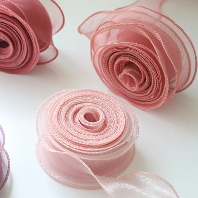 Pink organza ribbon rolled into decorative roses for DIY crafts and gift wrapping