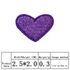 A purple heart shaped embroidery patch used for iron-on application.